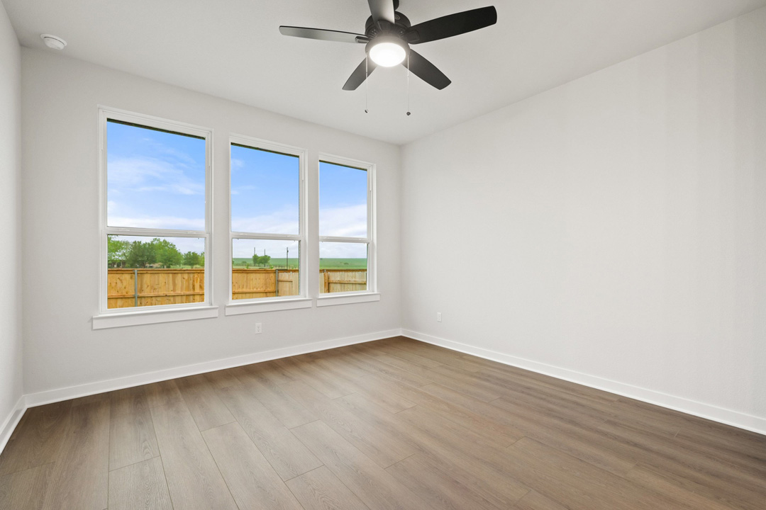 204 Bloomington Loop Hutto, TX 78634 - Photo 21 of 37 a view of an empty room with wooden floor and a window
