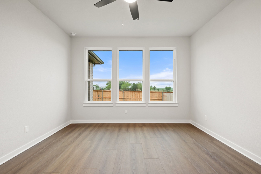 204 Bloomington Loop Hutto, TX 78634 - Photo 22 of 37 an empty room with window and wooden floor