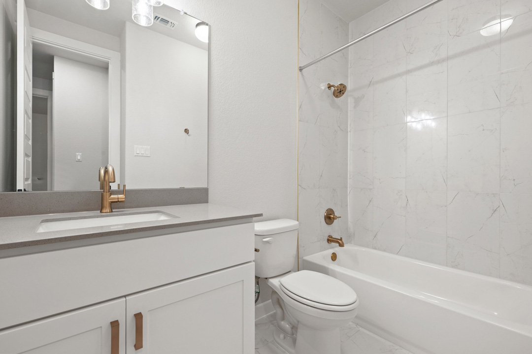 204 Bloomington Loop Hutto, TX 78634 - Photo 28 of 37 a bathroom with a sink a toilet and shower