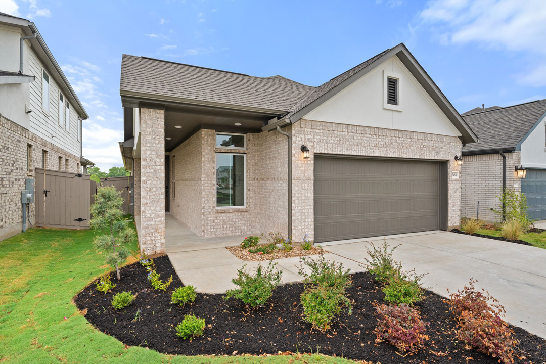 204 Bloomington Loop Hutto, TX 78634 - Photo 4 of 37 a front view of a house with a yard and garage