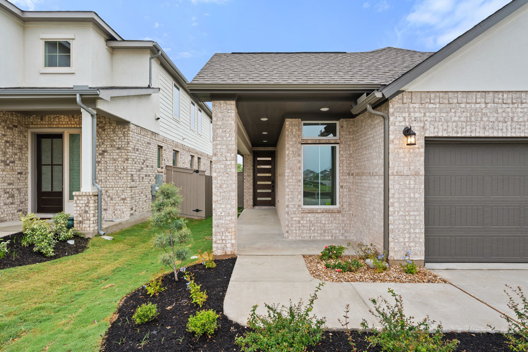 204 Bloomington Loop Hutto, TX 78634 - Photo 5 of 37 a front view of a house with garden