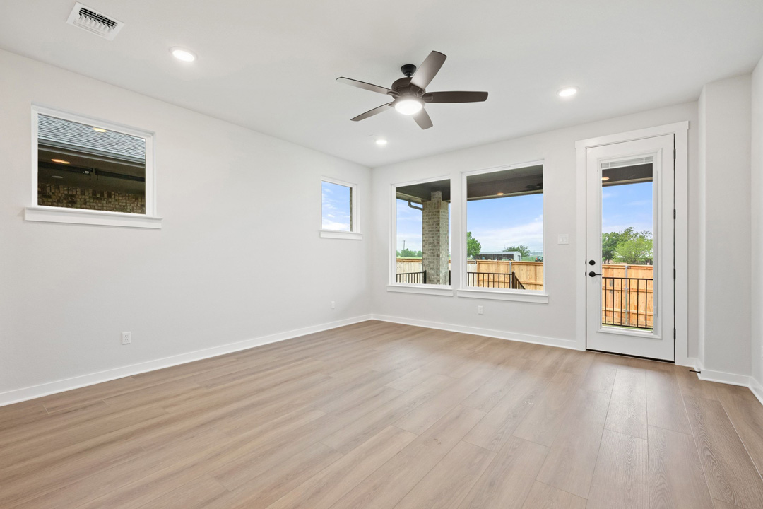 204 Bloomington Loop Hutto, TX 78634 - Photo 8 of 37 a view of an empty room with wooden floor and a window