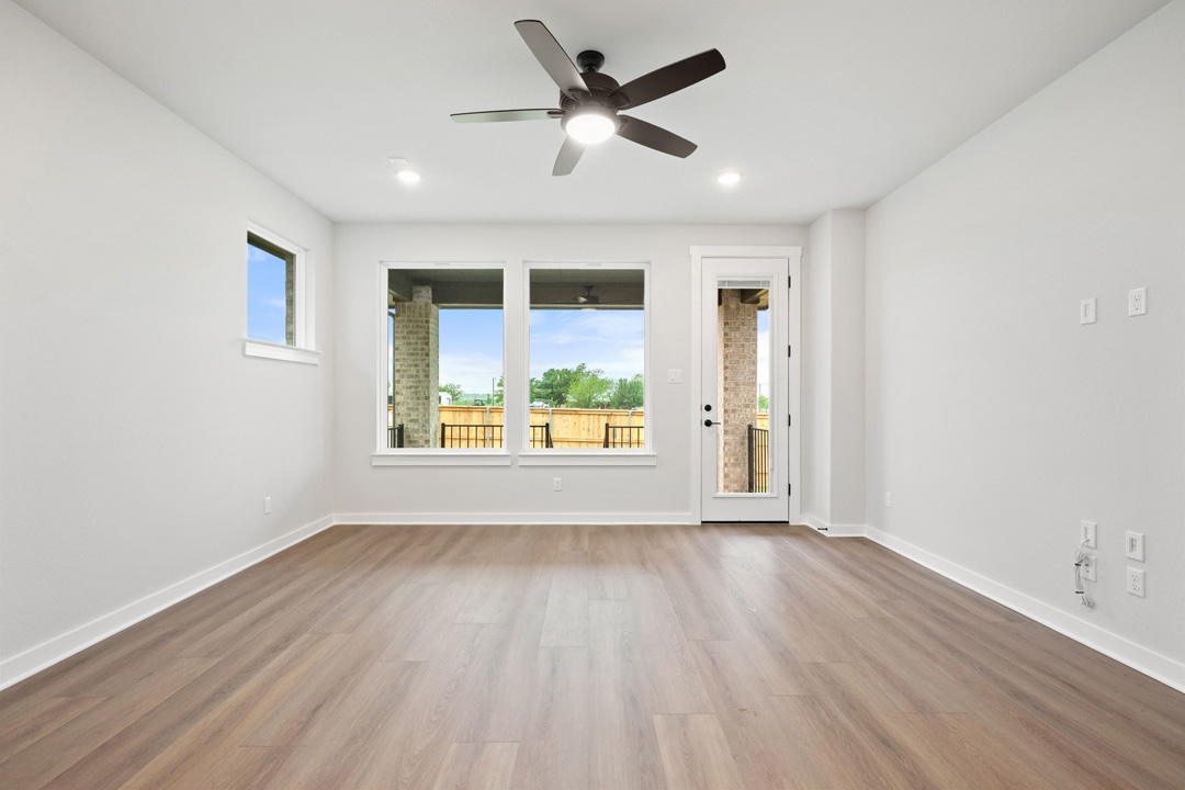 204 Bloomington Loop Hutto, TX 78634 - Photo 9 of 37 a view of an empty room with a window and wooden floor