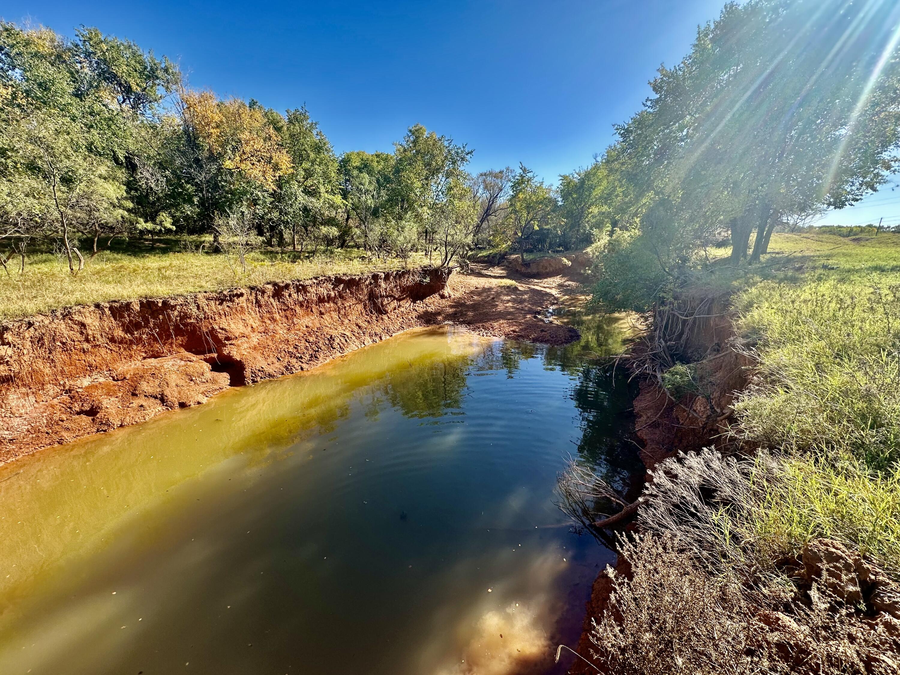 5 115 /- Acres State Highway Turkey, TX 79261 - Photo 21 of 28 a view of a lake with a yard