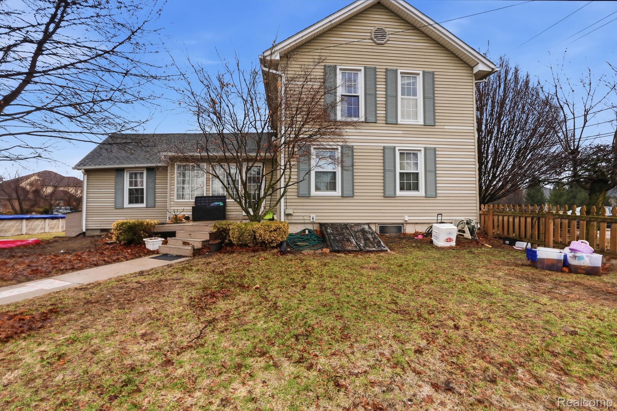 49777 Card Road Macomb, MI 48044 - Photo 16 of 18 Traditional-style house with a trampoline