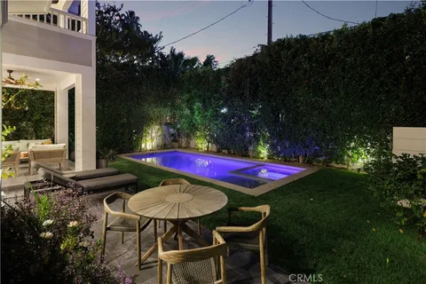 a view of a chairs and table in backyard
