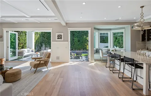 a living room with furniture and large windows