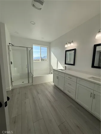 a view of a bathroom with double vanity sink and a mirror