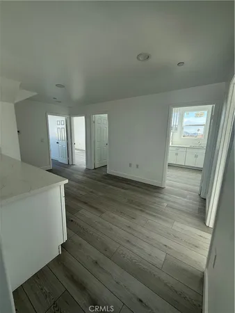 a view of a room with wooden floor and staircase
