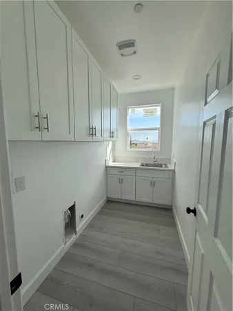a view of cabinets with wooden floor and window