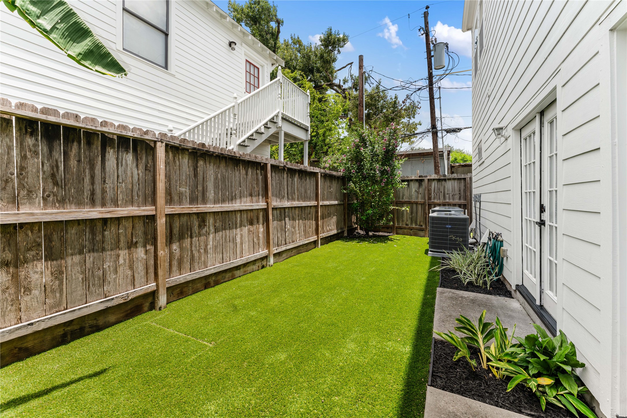 415 West 8th Street Houston, TX 77007 - Photo 18 of 39 Designed for low-maintenance living, the backyard combines lush artificial turf, established landscaping, and privacy fencing to create an inviting outdoor space that's ready to enjoy from day one.
