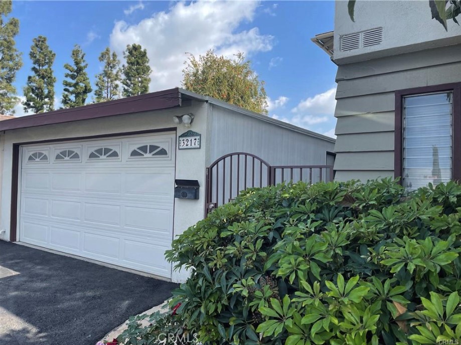 3217 Topaz Lane Fullerton, CA 92831 - Photo 2 of 23 a view of a house with a small yard and plants