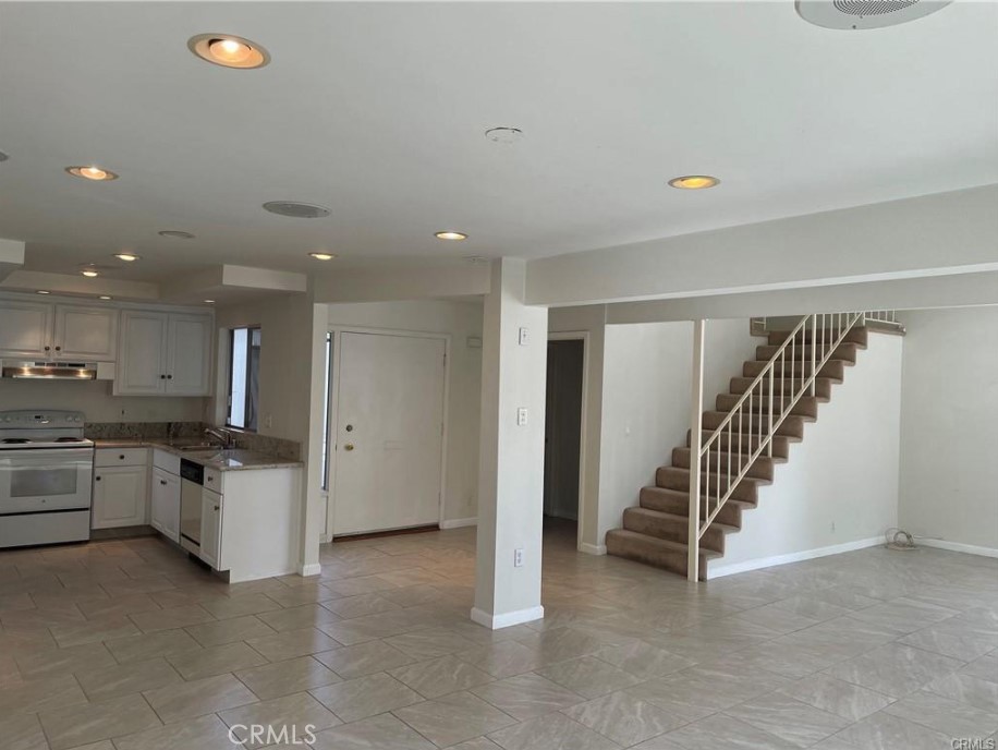 3217 Topaz Lane Fullerton, CA 92831 - Photo 6 of 23 a view of a kitchen with a sink and dishwasher a refrigerator with white cabinets