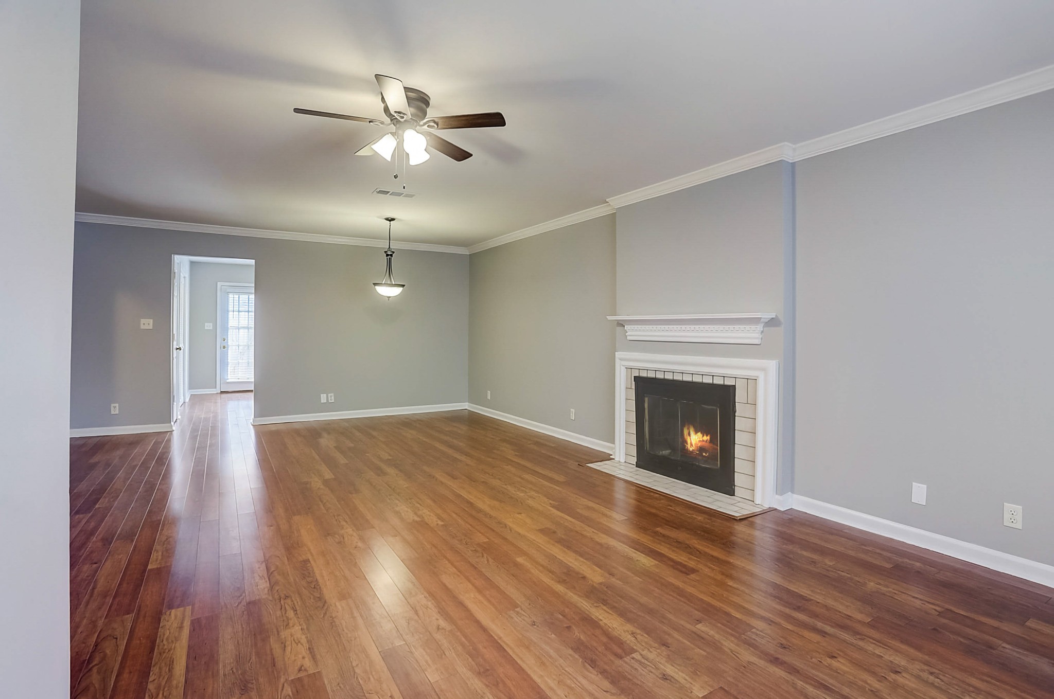 741 Kent Road Nashville, TN 37214 - Photo 4 of 25 a view of an empty room with wooden floor fireplace and a window