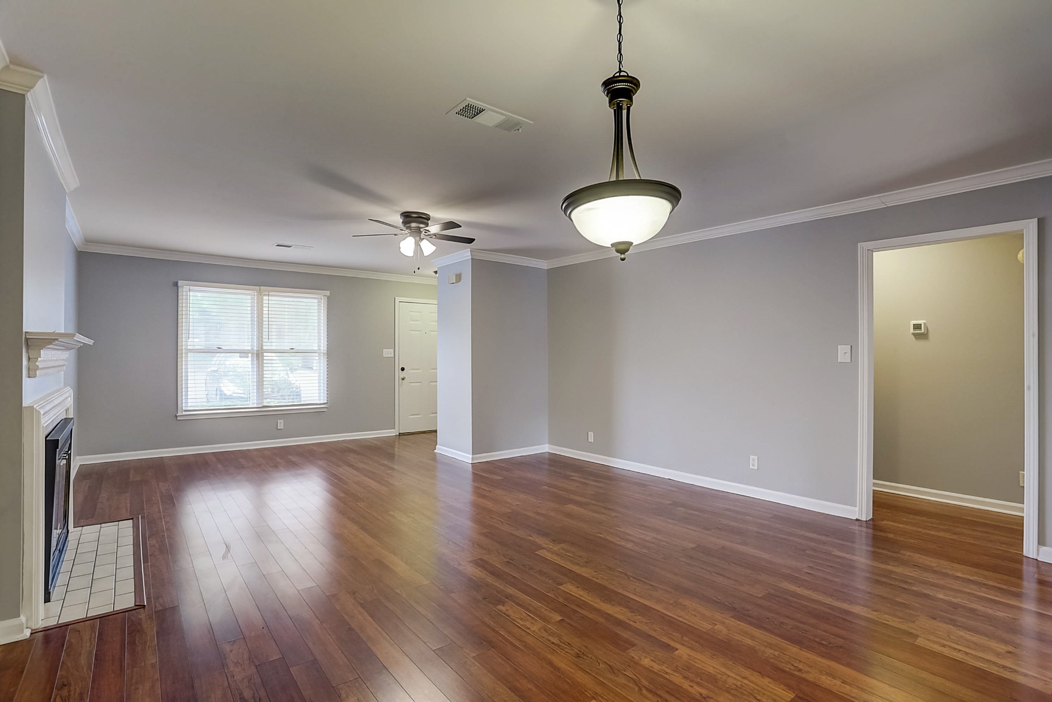 741 Kent Road Nashville, TN 37214 - Photo 5 of 25 a view of an empty room with wooden floor and a window