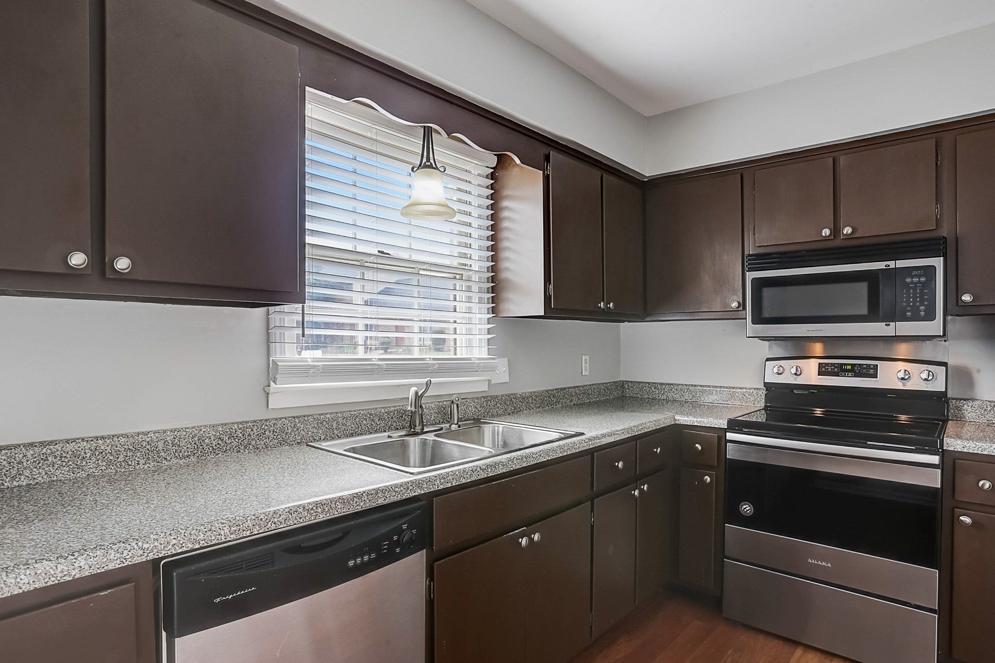741 Kent Road Nashville, TN 37214 - Photo 7 of 25 a kitchen with sink a microwave a stove and cabinets