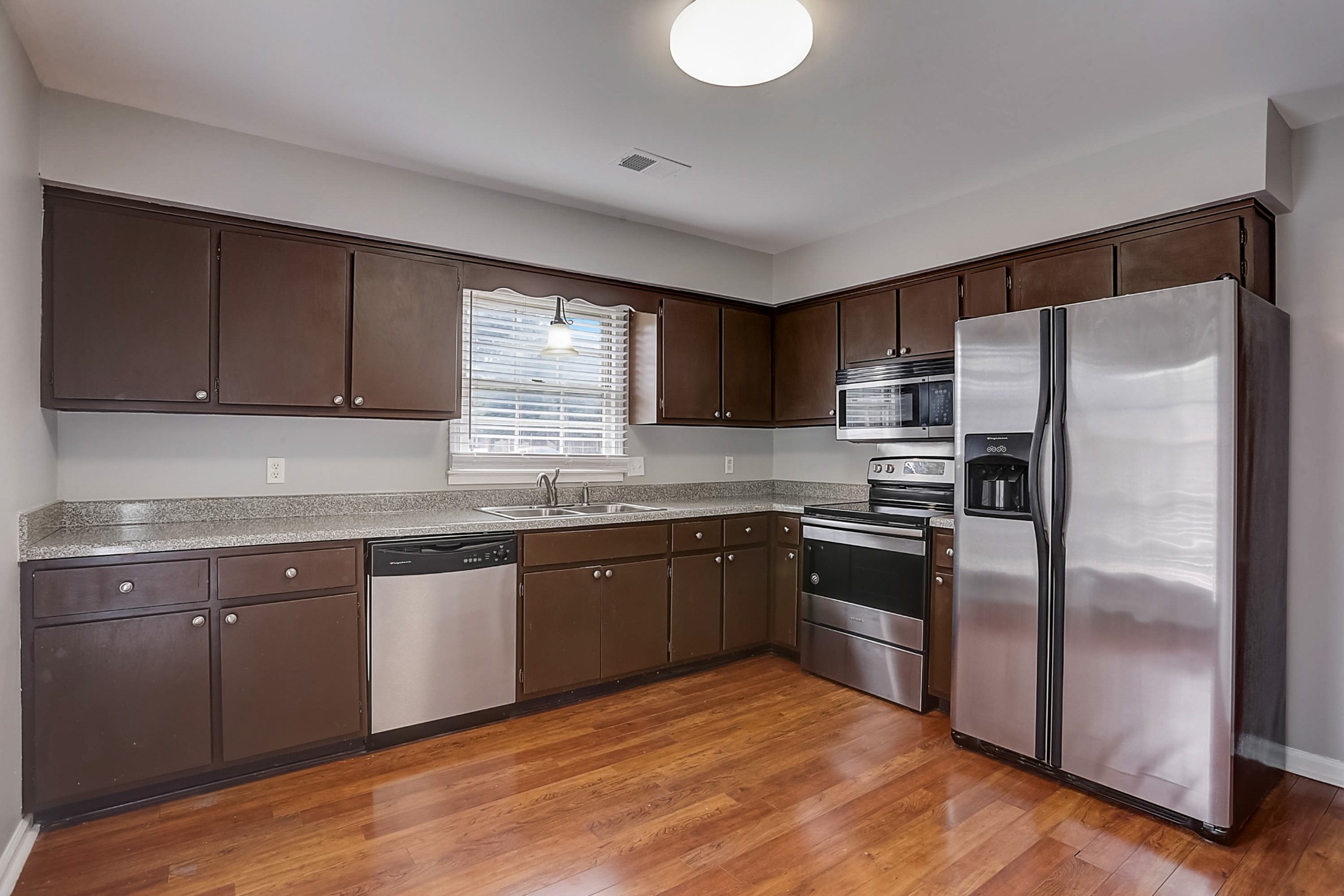 741 Kent Road Nashville, TN 37214 - Photo 8 of 25 a kitchen with granite countertop stainless steel appliances and wooden cabinets