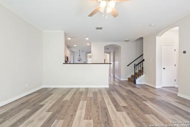 a view of a room with wooden floor and white walls