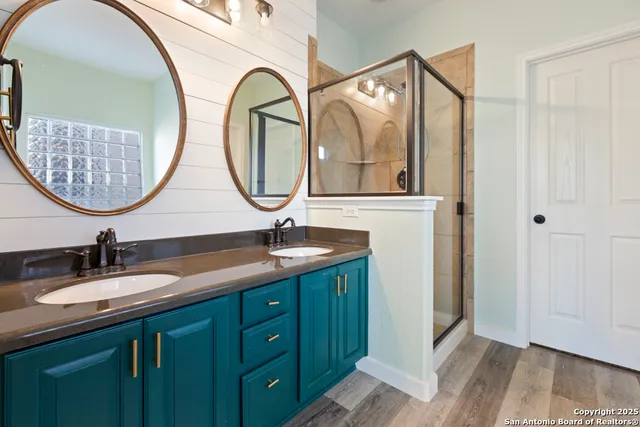 a bathroom with a double vanity sink and a mirror