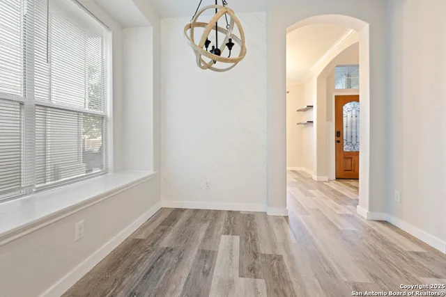 a view of a room with wooden floor windows and entryway