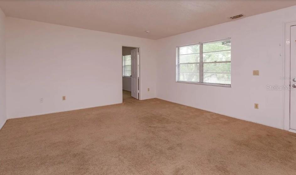 68 Windtree Lane, Unit 201 Winter Garden, FL 34787 - Photo 13 of 23 an empty room with windows
