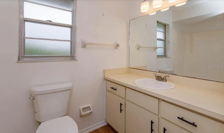 68 Windtree Lane, Unit 201 Winter Garden, FL 34787 - Photo 18 of 23 a bathroom with a toilet sink and mirror