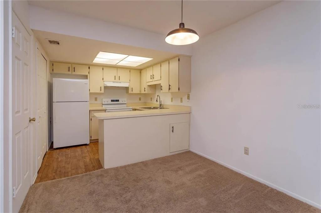 68 Windtree Lane, Unit 201 Winter Garden, FL 34787 - Photo 4 of 23 a utility room with cabinets washer and dryer