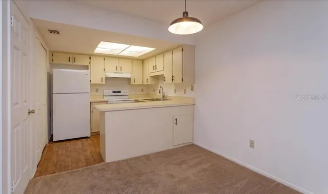 a utility room with cabinets washer and dryer