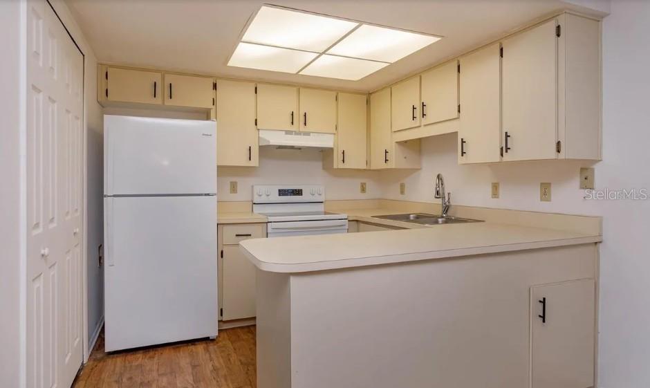 68 Windtree Lane, Unit 201 Winter Garden, FL 34787 - Photo 6 of 23 a kitchen with stainless steel appliances granite countertop a refrigerator sink and white cabinets