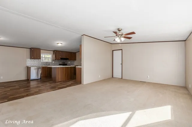 a view of a kitchen with a sink and a refrigerator
