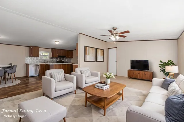 a living room with furniture a rug and a chandelier