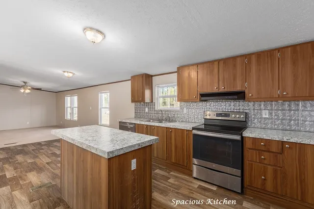 a kitchen with granite countertop wooden cabinets and white appliances