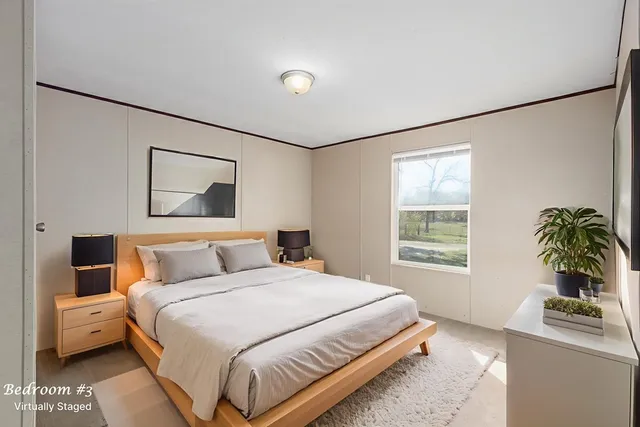 a bedroom with a bed and a potted plant