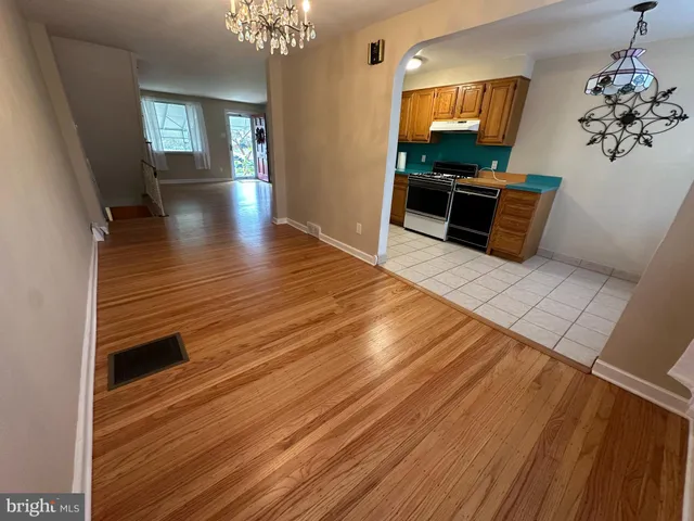 a view of a livingroom with wooden floor and a furniture