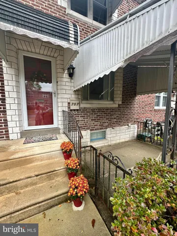 a front view of a house with outdoor seating