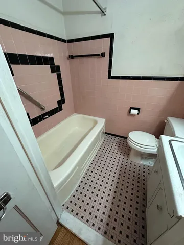 a bathroom with a toilet a sink and a mirror