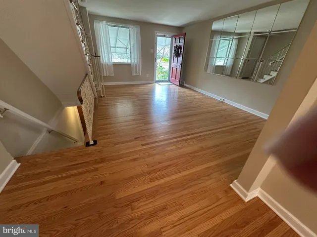 a view of an entryway with wooden floor