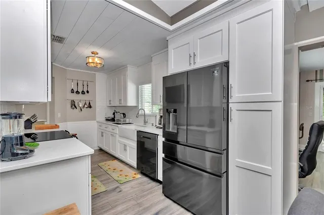 a kitchen with a refrigerator and cabinets