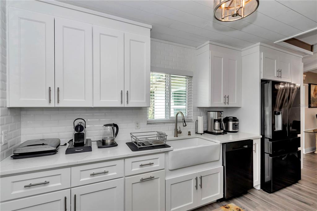 814 Oak Road Ocala, FL 34472 - Photo 35 of 52 a kitchen with white cabinets and refrigerator
