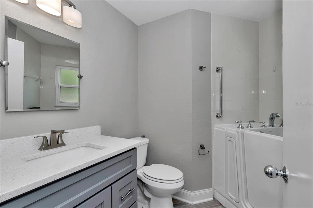814 Oak Road Ocala, FL 34472 - Photo 36 of 52 a bathroom with a granite countertop sink mirror and toilet