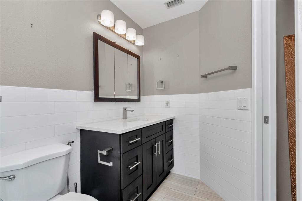 814 Oak Road Ocala, FL 34472 - Photo 43 of 52 a bathroom with a sink a toilet and a mirror