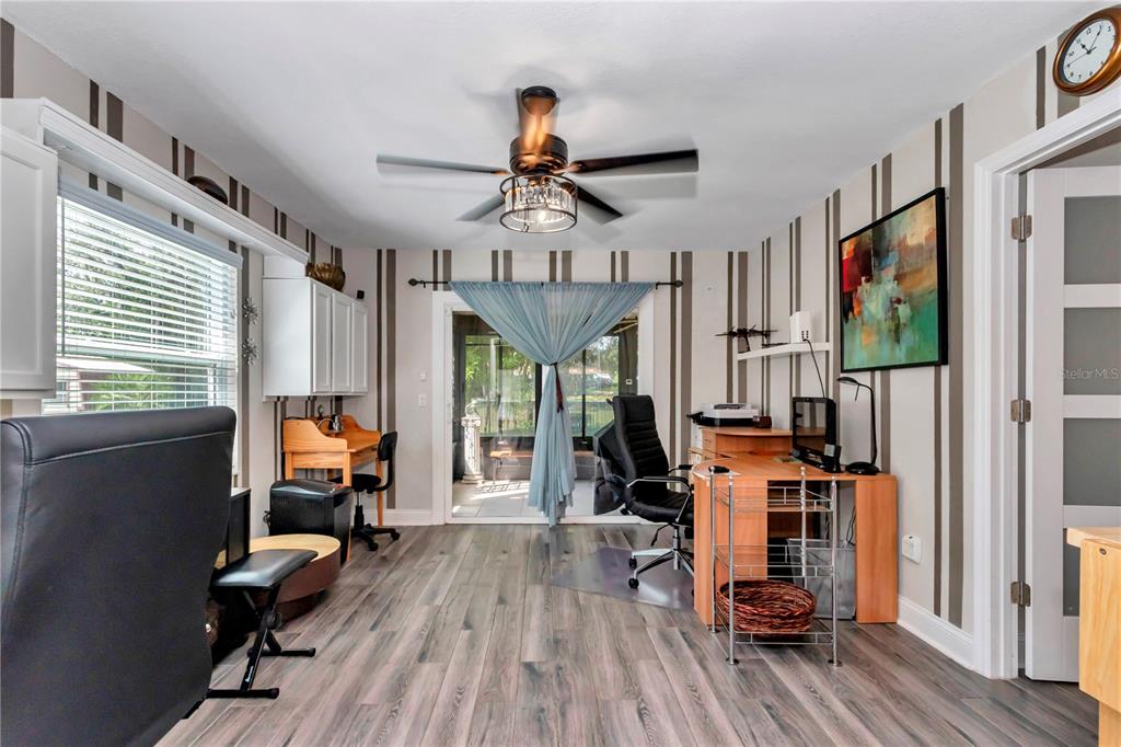 814 Oak Road Ocala, FL 34472 - Photo 45 of 52 a bedroom with furniture a chandelier and wooden floor