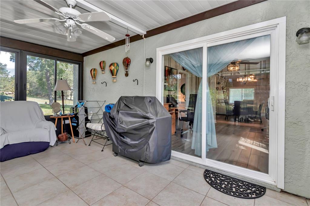 814 Oak Road Ocala, FL 34472 - Photo 48 of 52 a living room with furniture and a floor to ceiling window