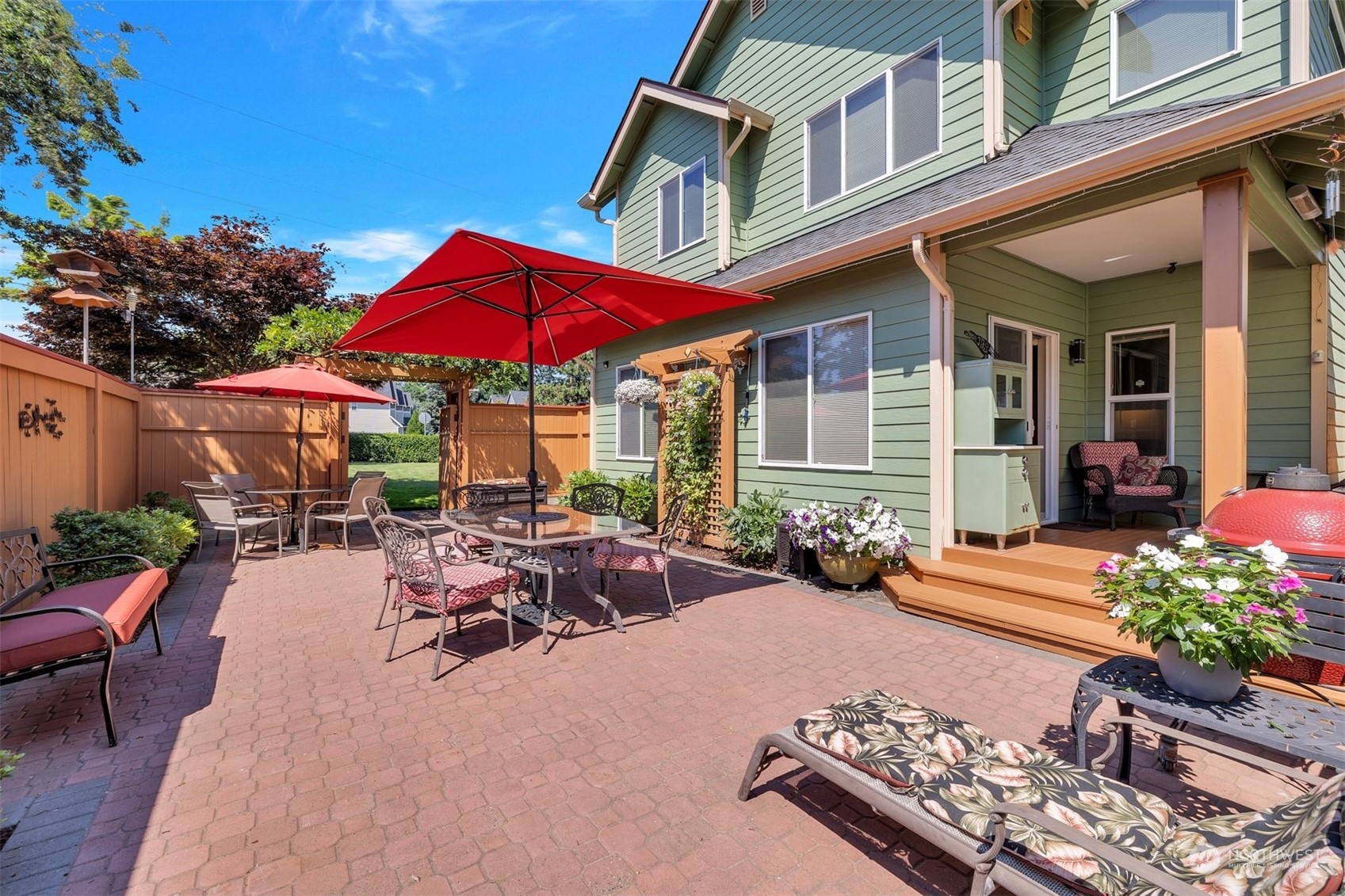 3807 Northeast 14th Street Renton, WA 98056 - Photo 13 of 34 a view of a patio with couches table and chairs under an umbrella
