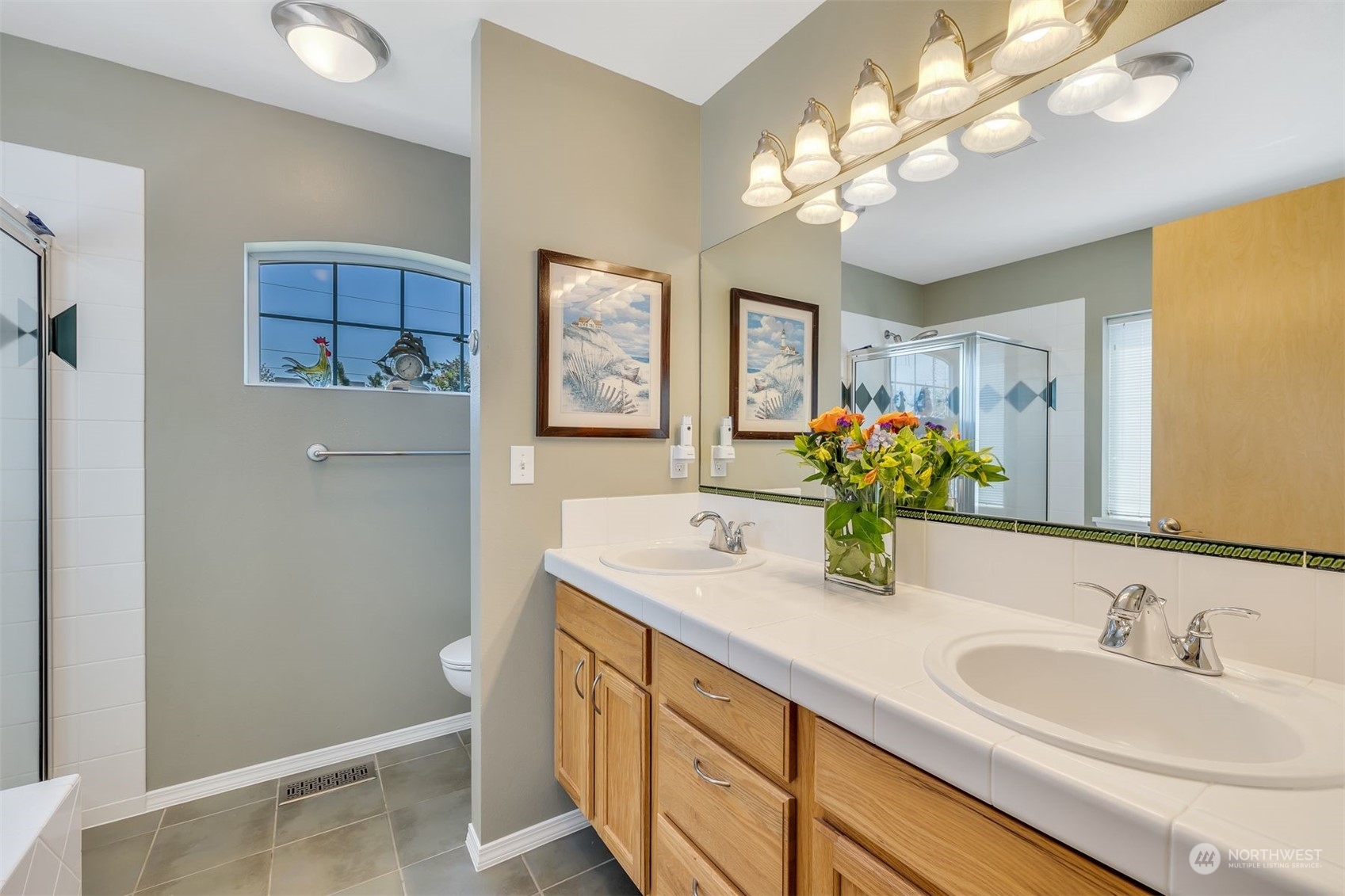 3807 Northeast 14th Street Renton, WA 98056 - Photo 17 of 34 a bathroom with a granite countertop sink a large mirror and a shower