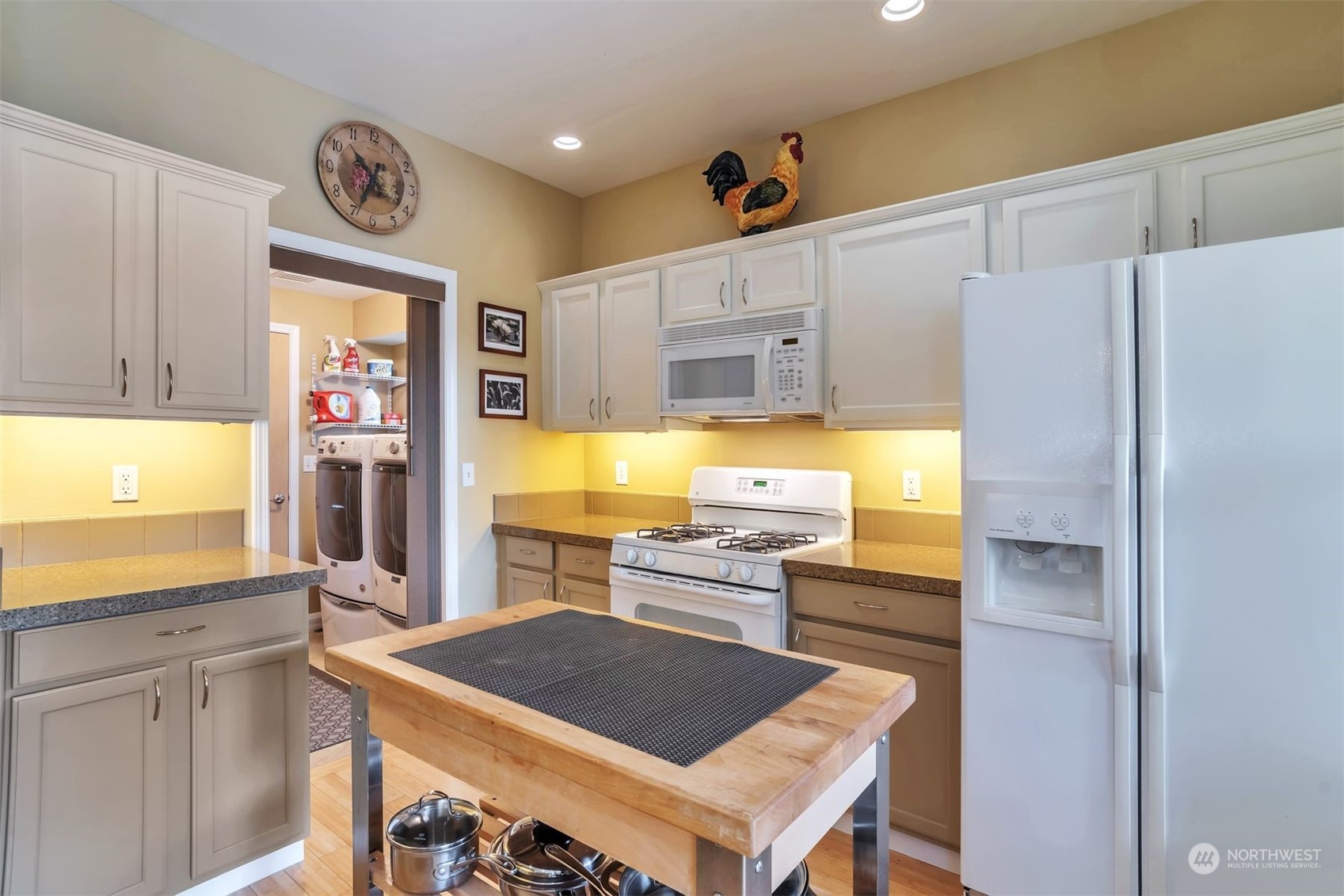 3807 Northeast 14th Street Renton, WA 98056 - Photo 6 of 34 a kitchen with stainless steel appliances granite countertop a refrigerator and a stove top oven