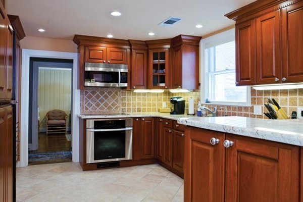 52 Oldham Road Newton, MA 02465 - Photo 6 of 11 a kitchen with stainless steel appliances granite countertop a stove sink and cabinets