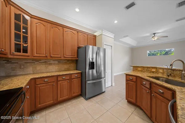 a kitchen with stainless steel appliances granite countertop a refrigerator and a sink