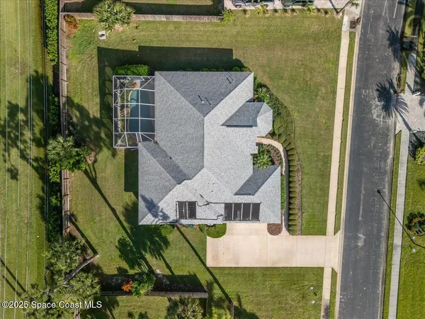 an aerial view of a house with outdoor space