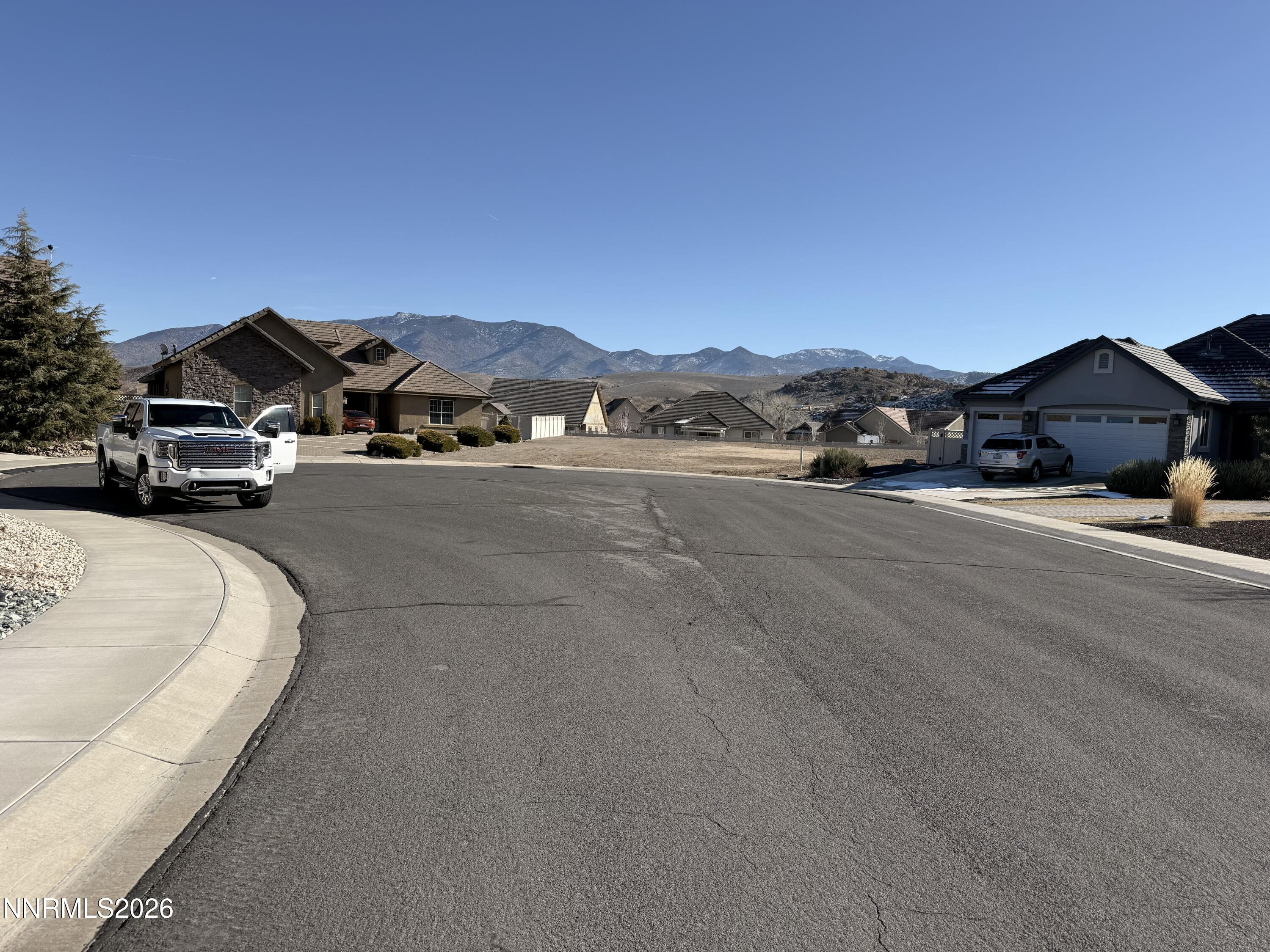317 San Roma Drive Dayton, NV 89403 - Photo 4 of 4 a view of a car parked in front of a house with a road